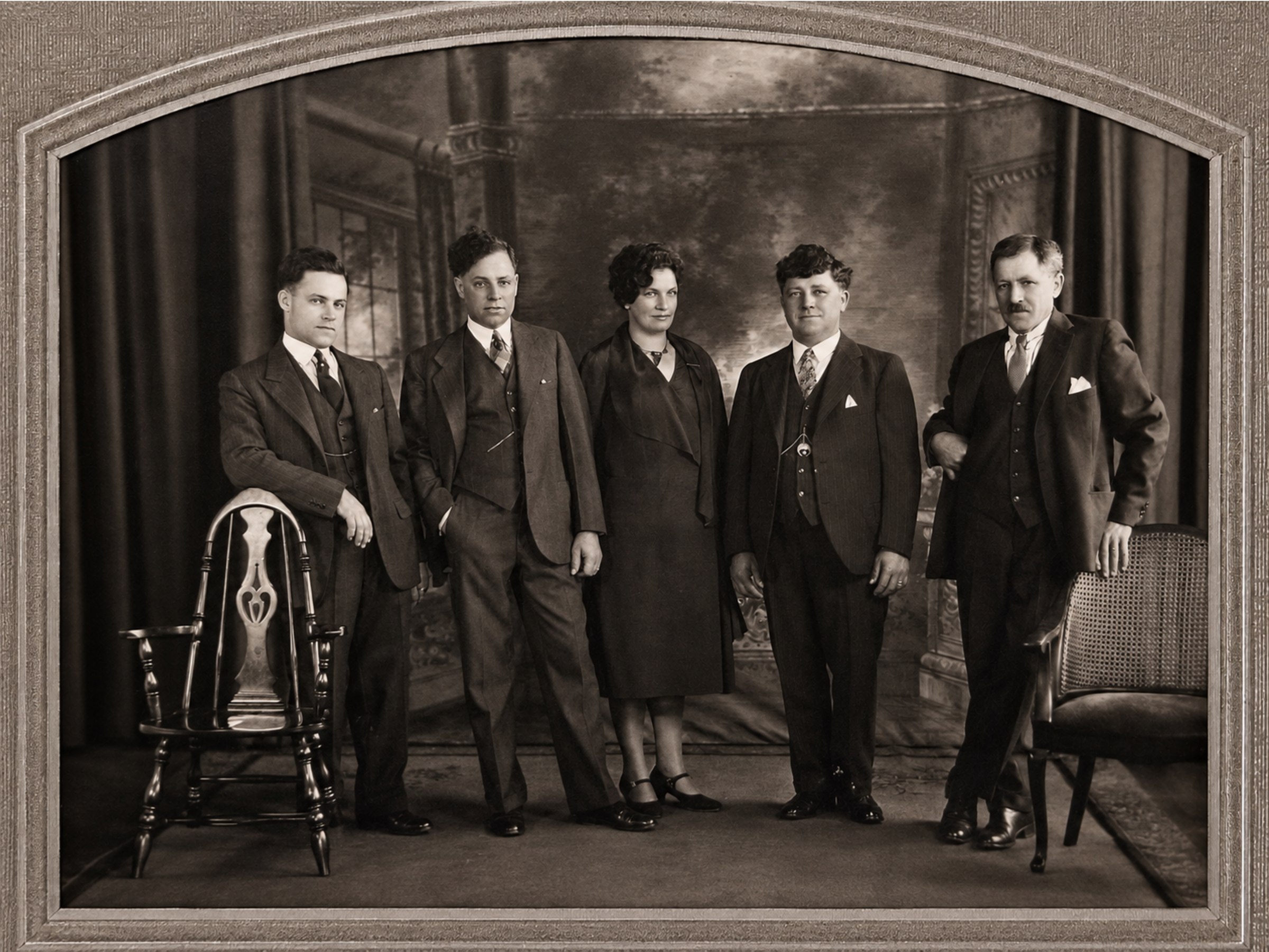 An archival studio portrait of five family members.